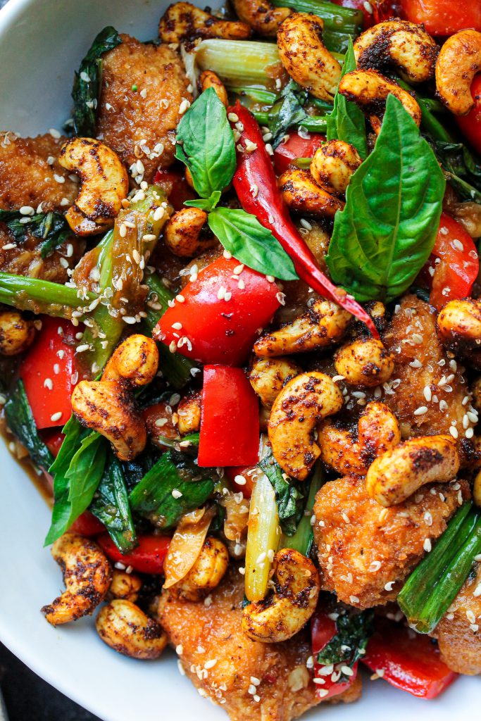 Close-up view of Thai Basil Tofu with Curry Roasted Cashews, showing crispy tofu, vibrant veggies, and roasted cashews.