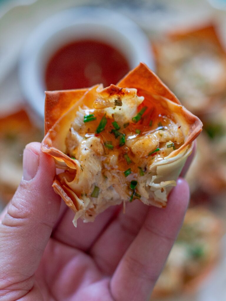 Plate of Vegan Crab Rangoon Wonton Cups served with sweet chili sauce for dipping.