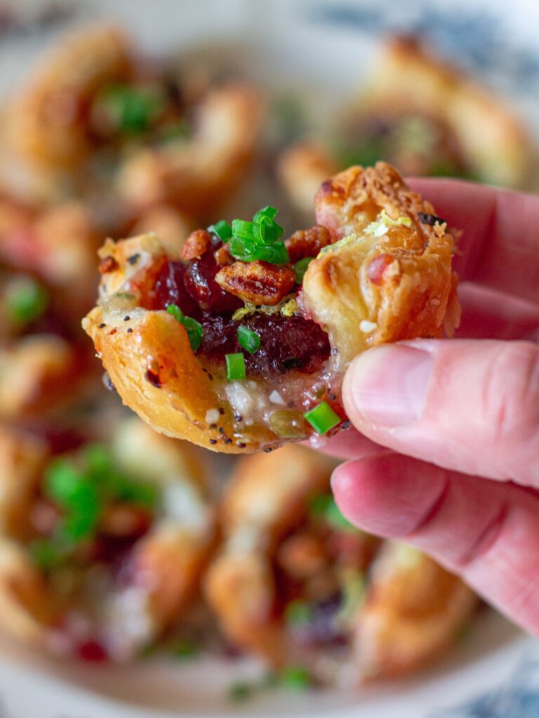 Close-up of the creamy herbed vegan cream cheese filling with visible flecks of green onion and minced garlic.